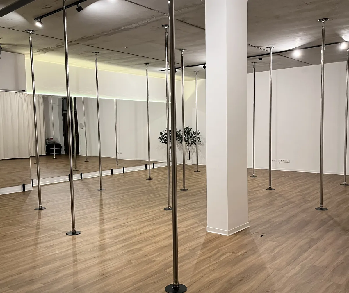 Main room in the evening, LED strip lighting the mirror wall behind the poles