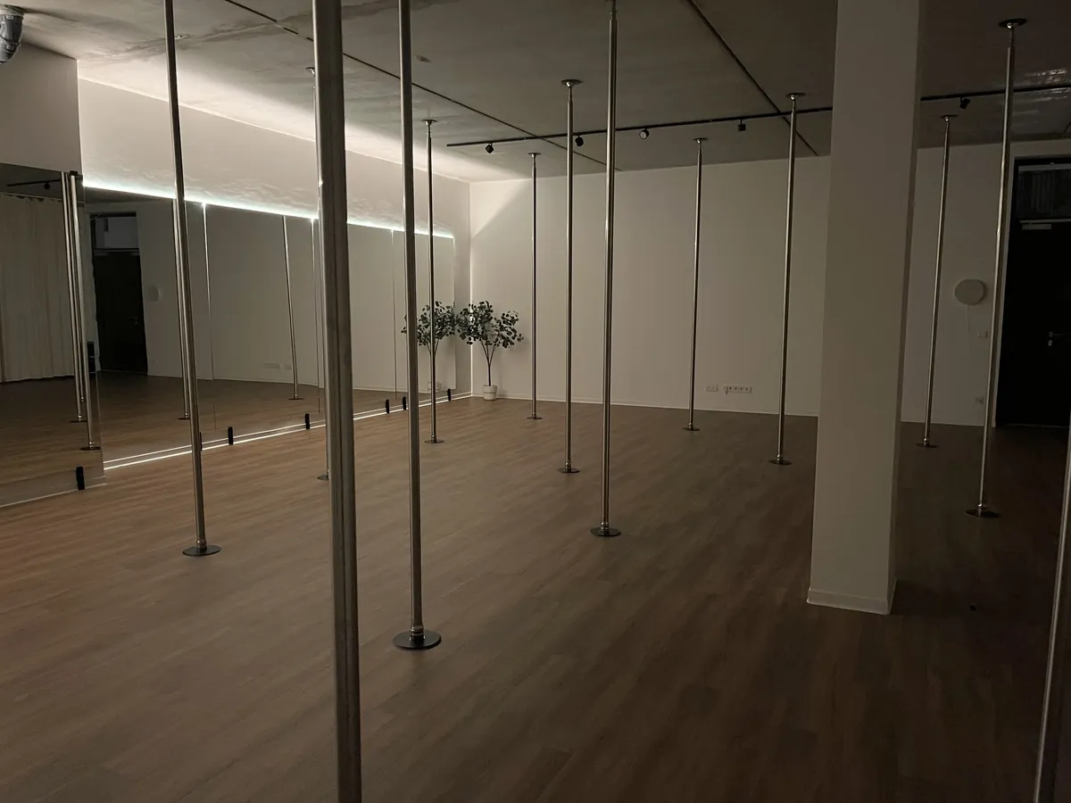 The studio at night, lit only by the LED strip along the mirror wall